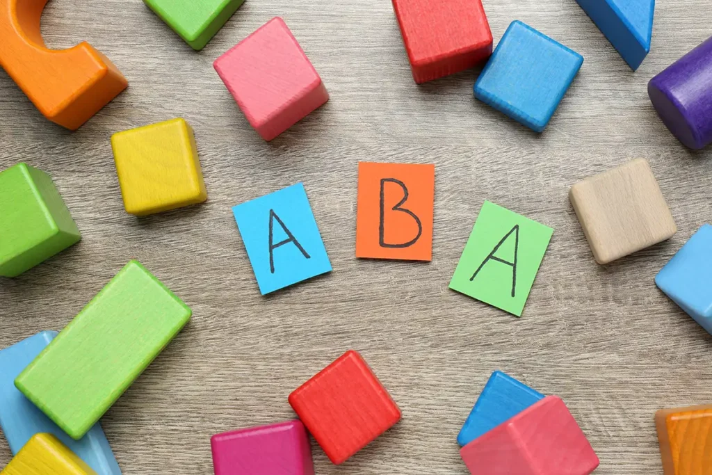 Applied Behavior Analysis (ABA) concept image with colorful blocks scattered on the floor - Collinsville, IL